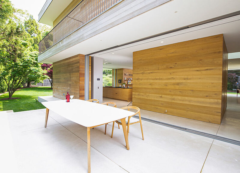 Hidden pocket doors and discreet shading to Long Island beach home.