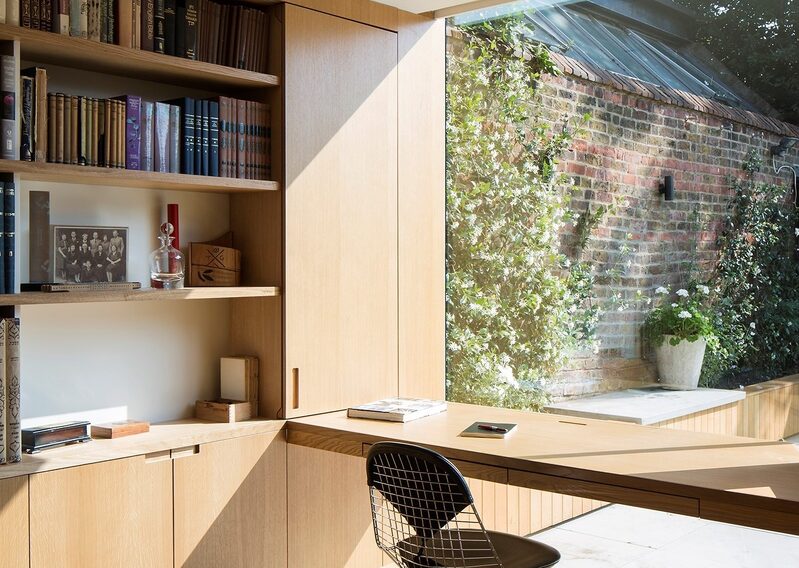 Home office directly beneath a large frameless window