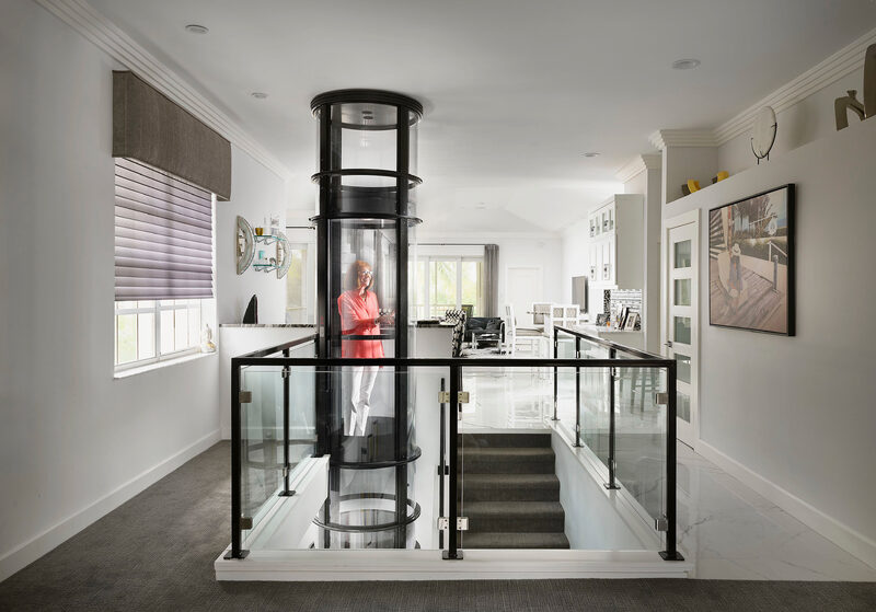 Home lift next to staircase in luxury home