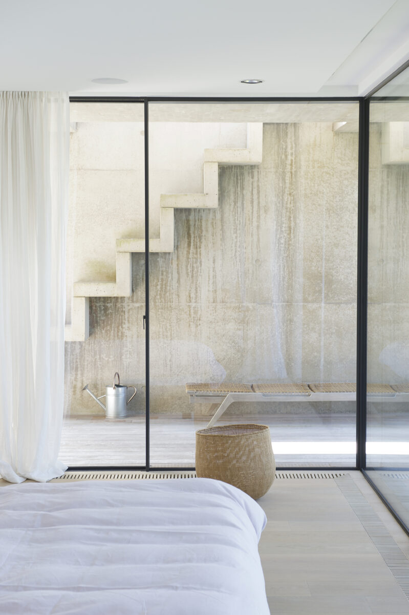 Floor-to-ceiling sliding glass doors used to flood the basement bedrooms with daylight