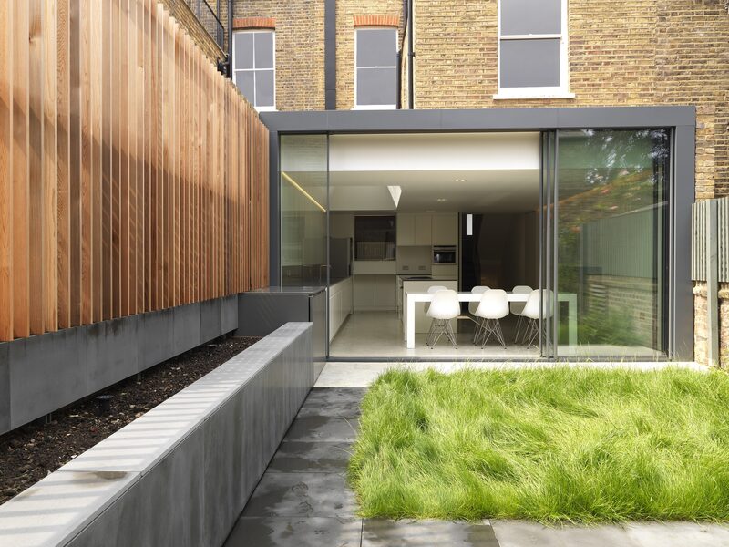 Anthracite grey aluminium systems with timber windows on the first floor