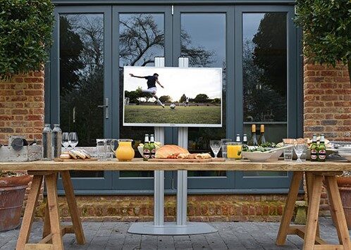 Outdoor entertainment space with TV on stand