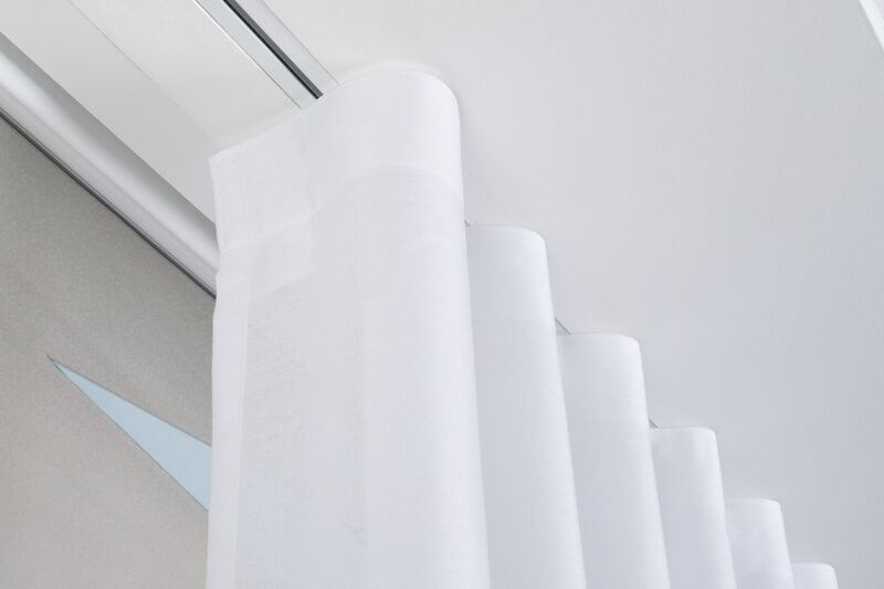 Soft white curtains on a recessed curtain track