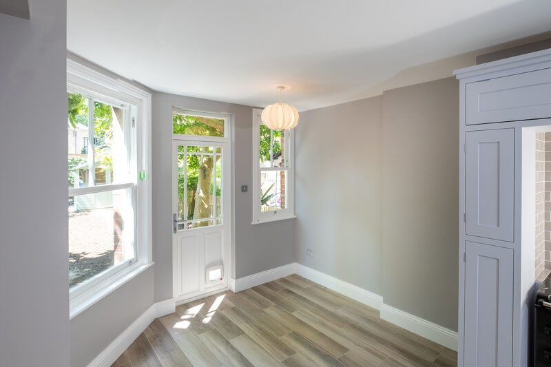 Single timber casement door with integrated cat flap