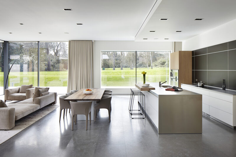 Minimal interior design scheme in kitchen dining area of luxury home, with floor to ceiling glass walls