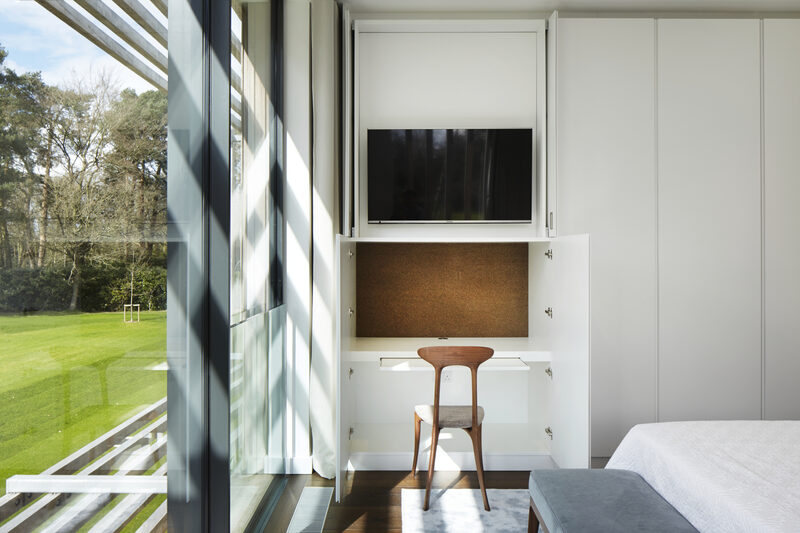 Compact home office next to architectural glazing installation