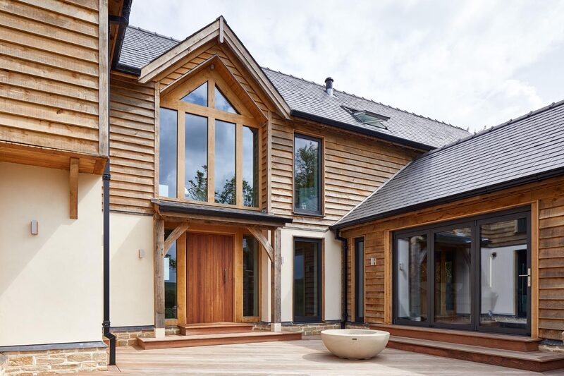 Iroko Doorset on Oak Framed House by Urban Front