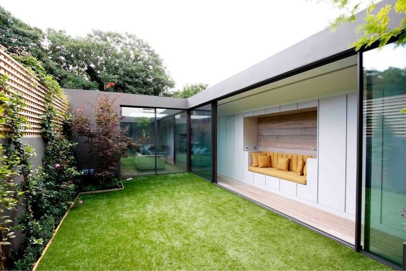 minimal sliding glass doors opening onto small courtyard garden