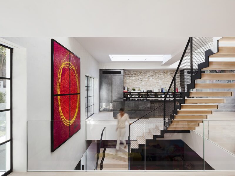 White walls and minimal interior design with large coloured artwork on display