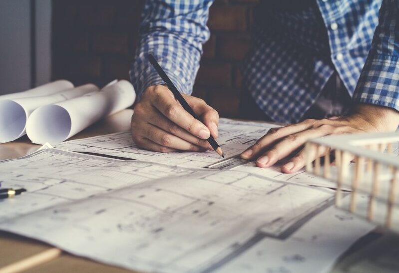 architect drawing plans for new build dwelling