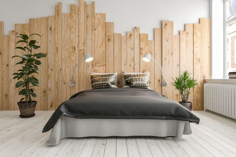 bedroom with natural wood wall paneling and house plants
