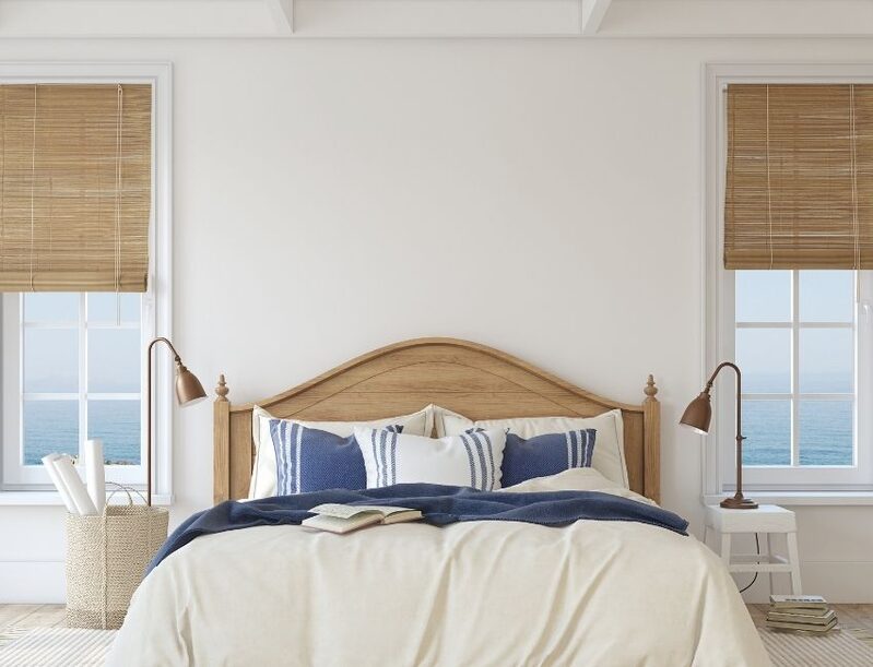 beachfront bedroom with natural wood blinds and bed frame
