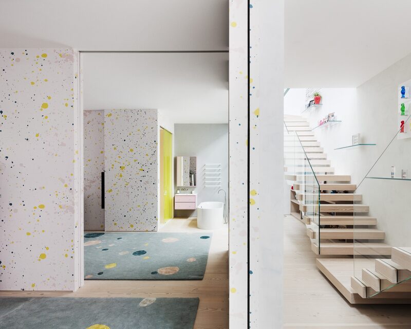 Contemporary interior design with patterned wallpaper and coloured accents