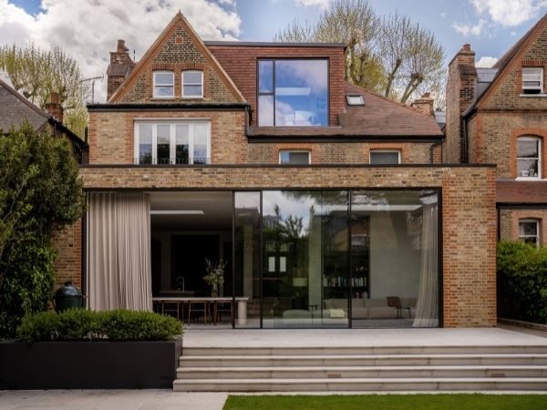 contemporary rear home extension with oversized sliding glass doors