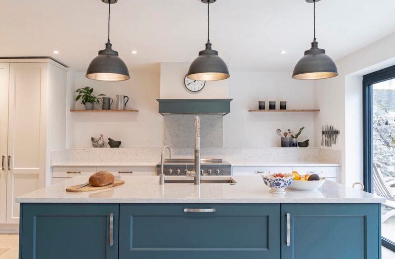 Contemporary kitchen in a pale white palette with Farrow & Ball blue accent colours