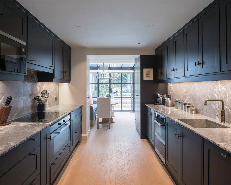 Internal view of kitchen leading to glass box extension