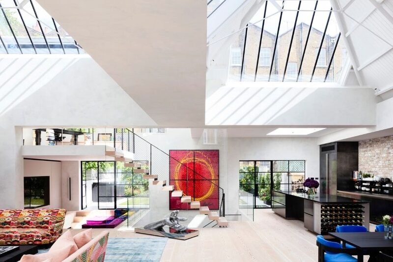 high end contemporary interior design in living room with internal glass balustrade and glass roof