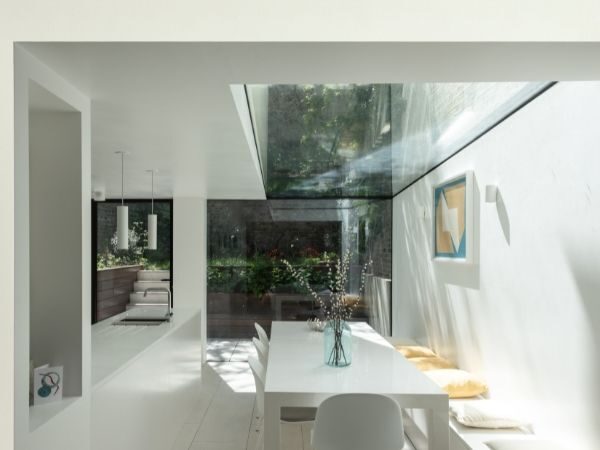 internal view of minimal glass extension with frameless up and over glazing
