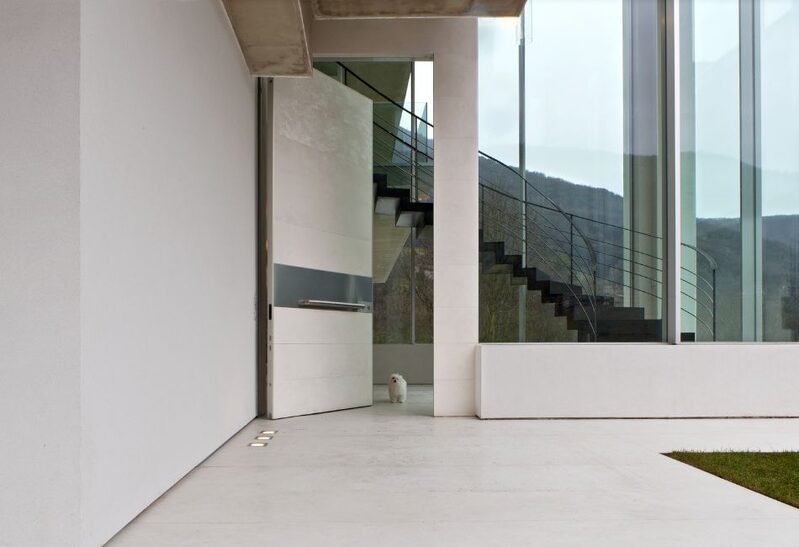 Apertio solid entrance door with white porcelain finish in contemporary home