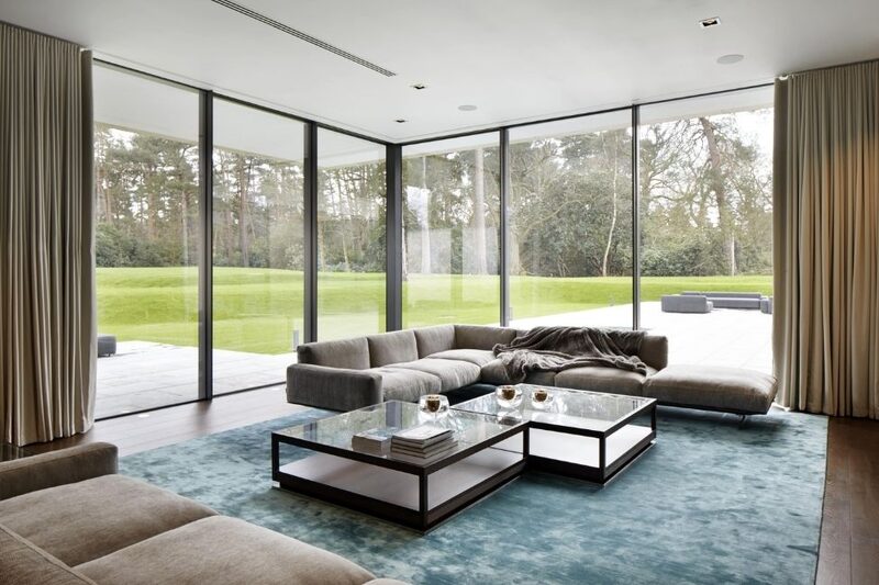 modern interior design in living room with floor to ceiling glazing