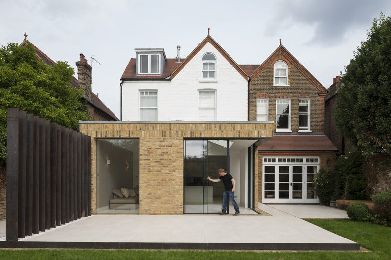 Corner opening aluminium sliding doors with timber windows on the first floor - Tigg Coll Architects