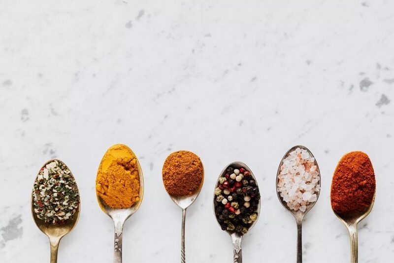 marble countertop with spoons holding spices