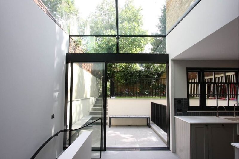 minimal framed sliding glass doors leading onto small garden