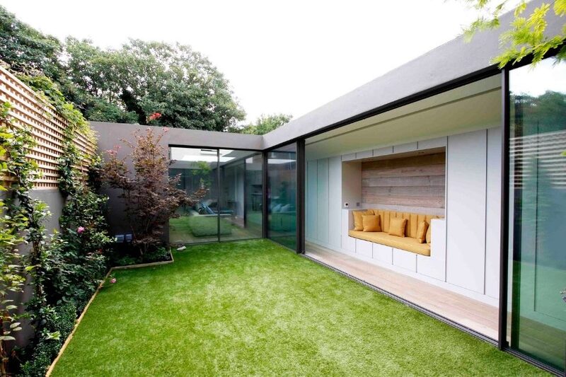 minimal sliding glass doors opening onto small courtyard garden