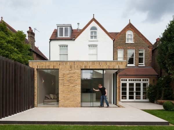 home extension with sliding glass doors in an opening corner, pocket door configuration - with Tigg Coll Architects