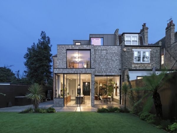 double height home extension with tall sliding glass doors