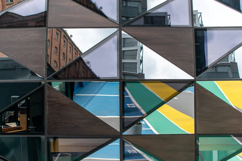 a mix of oak veneer panels and glass panes within a slim steel structure