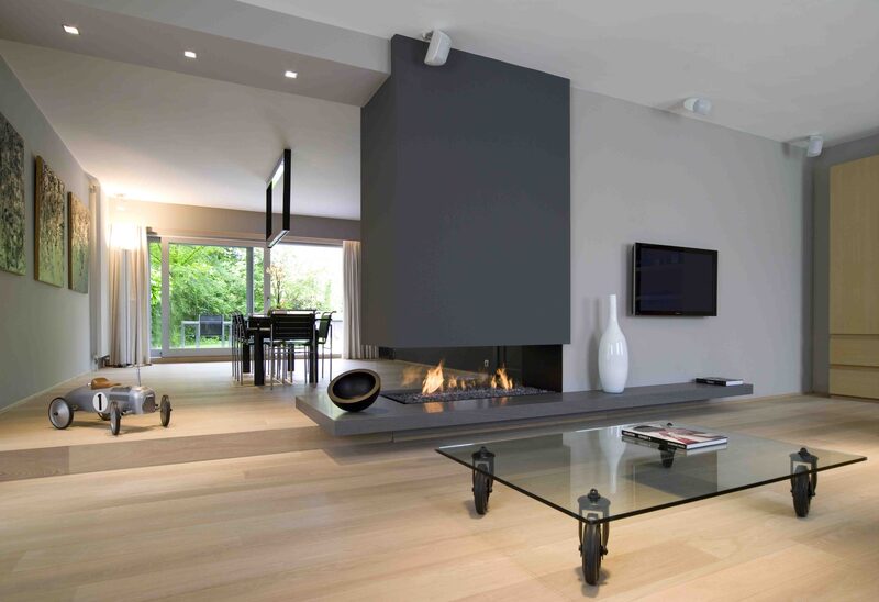 Three sided fireplace integrated in statement charcoal pillar