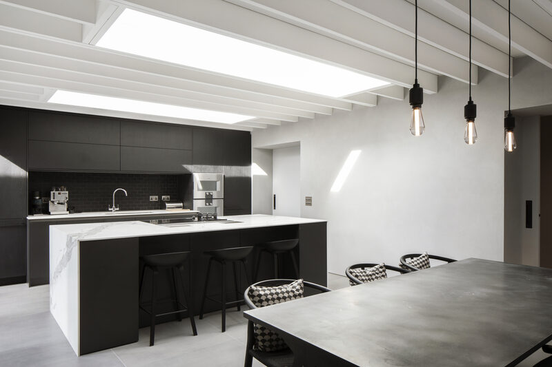 Black and white colour scheme in open plan kitchen dining area
